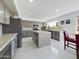 Modern kitchen featuring gray cabinets, stainless steel appliances, a large island and white countertops at 12403 W Monte Vista Rd Rd, Avondale, AZ 85392