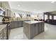 Bright open-concept kitchen featuring gray cabinets, stainless steel appliances, and access to the dining and living spaces at 12403 W Monte Vista Rd Rd, Avondale, AZ 85392