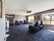Cozy living room featuring a ceiling fan, plush seating, neutral walls, and natural light from the large window at 12403 W Monte Vista Rd Rd, Avondale, AZ 85392