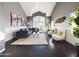Bright living room with high ceilings, a cozy sofa, plush chairs, stylish decor, and natural light at 12403 W Monte Vista Rd Rd, Avondale, AZ 85392