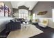 Bright living room with high ceilings, a cozy sofa, plush chairs, stylish decor, and natural light at 12403 W Monte Vista Rd Rd, Avondale, AZ 85392