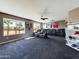Spacious living room featuring plush seating, neutral walls, and natural light from the large window at 12403 W Monte Vista Rd Rd, Avondale, AZ 85392