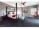 Beautiful main bedroom with a four-poster bed, ceiling fan, and neutral decor at 12403 W Monte Vista Rd Rd, Avondale, AZ 85392