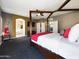 Spacious main bedroom showcasing a four-poster bed, ensuite access, and neutral tones at 12403 W Monte Vista Rd Rd, Avondale, AZ 85392