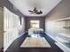 Spacious office with dark wood floors, modern desk, ceiling fan, and white rug at 12403 W Monte Vista Rd Rd, Avondale, AZ 85392