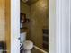 Compact powder room with toilet, shelves, and magazine rack, perfect for guests at 12403 W Monte Vista Rd Rd, Avondale, AZ 85392