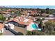 Aerial view showcasing a red-tiled roof house with a sparkling blue swimming pool and lush landscaping at 12448 N 76Th St, Scottsdale, AZ 85260