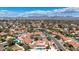 Panoramic aerial view of the suburban neighborhood showcasing red tile roofs and mountain views in the background at 12448 N 76Th St, Scottsdale, AZ 85260