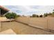 Fenced backyard with a gate and gravel landscaping, offering privacy and space for outdoor enjoyment at 12448 N 76Th St, Scottsdale, AZ 85260