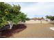 Backyard with an orange tree, gravel landscaping, and a fence, providing a serene outdoor environment at 12448 N 76Th St, Scottsdale, AZ 85260