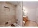 Bathroom featuring a walk-in shower with travertine tile and a built-in niche at 12448 N 76Th St, Scottsdale, AZ 85260
