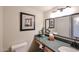 Bathroom sink with granite countertop and framed mirror at 12448 N 76Th St, Scottsdale, AZ 85260