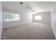 Spacious bedroom with neutral carpet, white walls, ceiling fan, and large windows offering ample natural light at 12448 N 76Th St, Scottsdale, AZ 85260