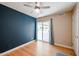 Bedroom with a ceiling fan, hardwood floors, and sliding glass doors leading to the patio at 12448 N 76Th St, Scottsdale, AZ 85260