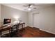 Bedroom featuring hardwood floors, a ceiling fan, and a classic desk for a functional workspace at 12448 N 76Th St, Scottsdale, AZ 85260