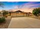 Home exterior showing garage, extended driveway, mature trees, and desert landscaping at 12448 N 76Th St, Scottsdale, AZ 85260