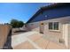 Exterior view of the home featuring a beige exterior with a blue roof, landscaping, and a private entrance at 12448 N 76Th St, Scottsdale, AZ 85260
