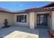 Home featuring a tiled entrance, glass front door, and desert landscaping at 12448 N 76Th St, Scottsdale, AZ 85260