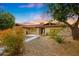 Charming home showcasing desert landscaping, mature trees, and a tiled walkway leading to the entrance at 12448 N 76Th St, Scottsdale, AZ 85260