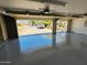 Spacious garage with epoxy flooring and an open view of the driveway and street at 12448 N 76Th St, Scottsdale, AZ 85260
