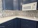 Close up of the kitchen featuring blue cabinets, white countertops and backsplash at 12448 N 76Th St, Scottsdale, AZ 85260