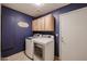Laundry room features modern washer and dryer with lots of cabinets at 12448 N 76Th St, Scottsdale, AZ 85260