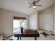 Bright living room featuring stylish tile flooring, modern ceiling fan, and a table near the window at 12448 N 76Th St, Scottsdale, AZ 85260