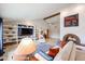 Sun-filled living room offering a fireplace, vaulted ceiling, and decorative shelving at 12448 N 76Th St, Scottsdale, AZ 85260