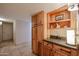 Pantry with wooden cabinets and drawers and lots of shelves for storage at 12448 N 76Th St, Scottsdale, AZ 85260