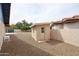 Backyard shed with neutral paint, surrounded by gravel landscaping, offering extra storage space at 12448 N 76Th St, Scottsdale, AZ 85260