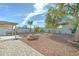 Beautiful backyard with low-maintenance landscaping, charming fire pit, and ample space for outdoor entertaining at 12621 W Aster Dr, El Mirage, AZ 85335