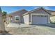 Charming single-story home featuring a two-car garage and low-maintenance desert landscaping at 12621 W Aster Dr, El Mirage, AZ 85335