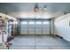 Spacious garage with overhead door, ample storage space, and room for vehicles and projects at 12621 W Aster Dr, El Mirage, AZ 85335