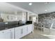 Bright, open kitchen with white cabinets, stainless steel sink, and views into the dining area at 12621 W Aster Dr, El Mirage, AZ 85335