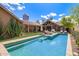 Inviting backyard with a refreshing pool, comfortable lounge seating, and views of the surrounding neighborhood at 130 W Palm Ln, Phoenix, AZ 85003