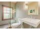 Modern bathroom featuring a walk-in shower with glass door, and stylish black and white tiled walls at 130 W Palm Ln, Phoenix, AZ 85003