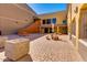 Community courtyard featuring stone picnic tables, manicured landscaping, and building access at 13029 N 111Th Ave, Sun City, AZ 85351