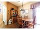 Dining room with wooden table set and hutch under a chandelier at 13029 N 111Th Ave, Sun City, AZ 85351