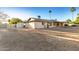 Spacious backyard featuring a shed and a covered patio, perfect for outdoor living and entertainment with mature landscaping at 14013 N 57Th Pl, Scottsdale, AZ 85254