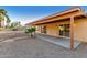 An exterior view of the backyard featuring a covered patio and low-maintenance rock landscaping at 14013 N 57Th Pl, Scottsdale, AZ 85254