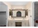 Bathroom featuring a double sink vanity, decorative mirrors, and wallpapered accent wall at 14013 N 57Th Pl, Scottsdale, AZ 85254