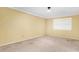 Empty bedroom with neutral walls, carpet, and a window providing natural light at 14013 N 57Th Pl, Scottsdale, AZ 85254