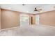 A well-lit living room features neutral walls, plush carpet, and sliding glass doors leading to the outdoor space at 14013 N 57Th Pl, Scottsdale, AZ 85254