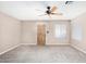 Open living room with carpet, a wooden front door, and a window at 14013 N 57Th Pl, Scottsdale, AZ 85254