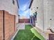 Backyard with artificial turf, brick pavers, and block wall at 14247 W Bronco Trl, Surprise, AZ 85387