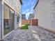 Brick paver backyard with small patch of turf and block fencing at 14247 W Bronco Trl, Surprise, AZ 85387