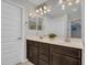 Bathroom with dual sink vanity, dark wood cabinets, and ample counter space at 14247 W Bronco Trl, Surprise, AZ 85387