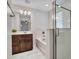 Bathroom featuring a soaking tub, shower, wood cabinets, and decorative lighting at 14247 W Bronco Trl, Surprise, AZ 85387