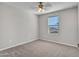 Neutral bedroom with plush carpeting, a ceiling fan, and a window for natural light at 14247 W Bronco Trl, Surprise, AZ 85387