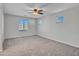 Spacious bedroom featuring neutral walls, carpet flooring, and multiple windows at 14247 W Bronco Trl, Surprise, AZ 85387